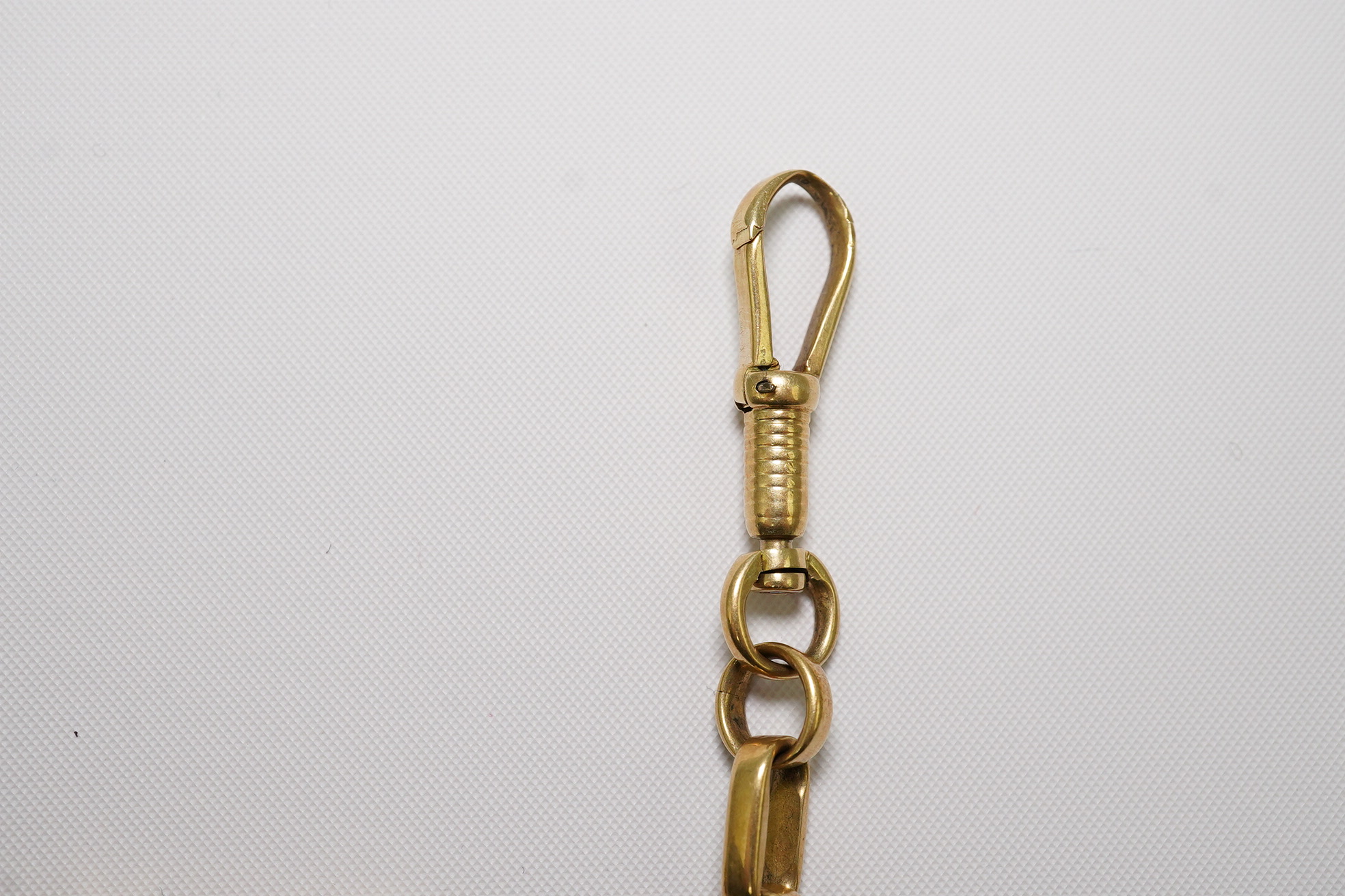 A gold oval link albert, hung with an 18ct and bloodstone set compass fob